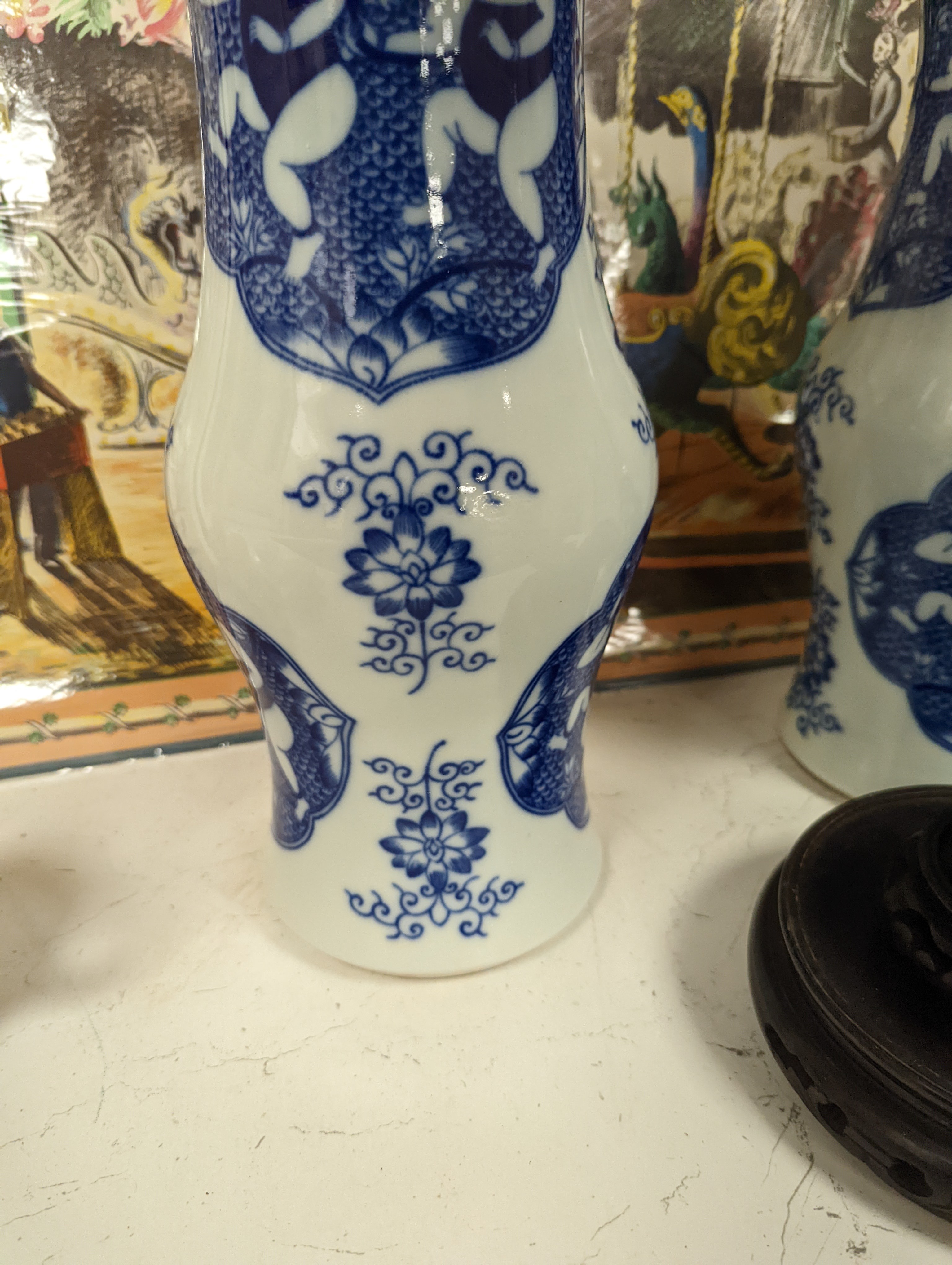 A pair of Chinese blue and white vases on stands and 4 further wood stands. Vases 35cm